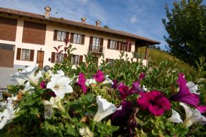 a house with flowers in front of it at Cascina La Corte in Neive