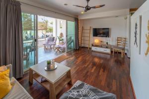 a living room with a couch and a table at Southern Lanta Apartments in Ko Lanta