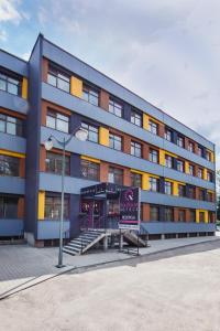 a large building with a sign in front of it at Boutique Hotel's Sosnowiec in Sosnowiec