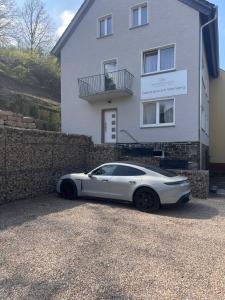 a white car parked in front of a house at Gästehaus am Weinberg in Oberheimbach