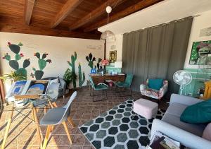 a living room with a couch and chairs and a desk at B&B Villa del Sole Relais in Agrigento