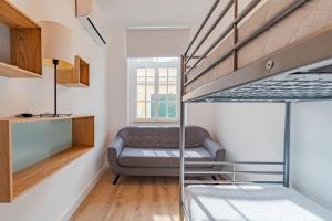 a living room with a couch and a bunk bed at Setúbal Oasis House, By Home Match in Setúbal
