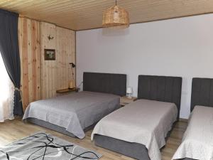 a room with two beds in a room at Ostoja Tatary Agroturystyka in Tykocin