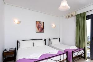 a bedroom with two beds and a table and a window at Lithorama Granitsa mountain rooms in Granitsa