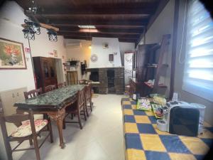 a room with a table and chairs and a kitchen at Mappet B&B in Melito di Porto Salvo