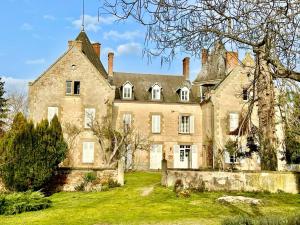 an old house with a grass yard in front of it at Chateau de Bouquetraud in Franchesse
