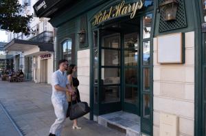 a man and a woman standing outside of a store at The Originals city, Hôtel Harys in Vichy