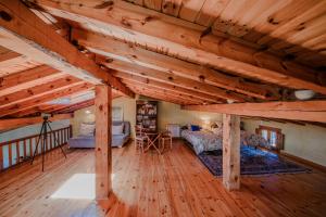 a large room with two beds and wooden ceilings at Casona del Tambor in Calatañazor