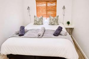 a large white bed in a room with pillows at Dolphin View 34 in Langstrand