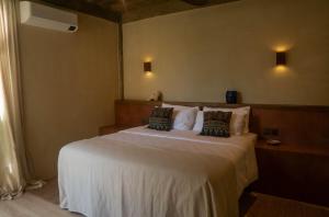 a bedroom with a large white bed with two pillows at Casa Kalma in General Luna +18 photos