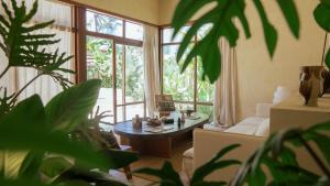 a living room with a table and some plants at Casa Kalma in General Luna
