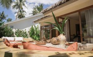 a table with a plant on top of a patio at Casa Kalma in General Luna