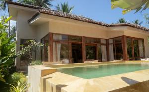 a house with a swimming pool in front of it at Casa Kalma in General Luna
