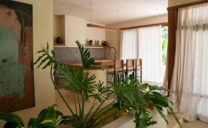 a kitchen with a table and some plants at Casa Kalma in General Luna