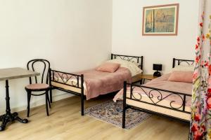 a room with two beds and a table and a desk at Ferienwohnung Otto in Pegnitz