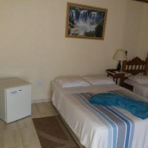 Uma cama ou camas num quarto em Pousada Desfiladeiro da Serra