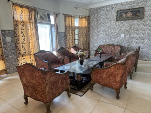 a dining room with a table and chairs at Skyview Stays I Party Lawns I Adjacent The Good Club I 1km Sukhna lake,Rock Garden & High Court I in Chandīgarh