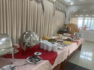 a table with a buffet of food on it at Bason Hotel Long Hải in Long Hai