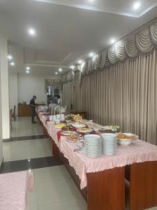 a buffet line with plates of food on a table at Bason Hotel Long Hải in Long Hai