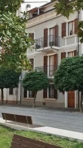 a white building with trees in front of it at Suite 21 - Residence Contini in Falconara Marittima