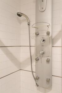 a shower with a shower head in a bathroom at Colinas Premium 3BR in Odivelas +42 photos
