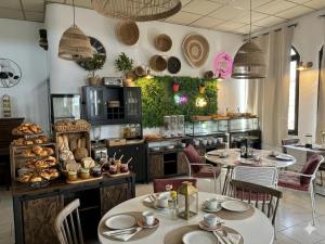 a restaurant with tables and chairs and a kitchen at GABRIELLE HOTEL in Aiguines