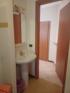 a bathroom with a sink and a mirror at Appartamento Vecchia Domo in Domodossola +10 photos