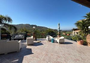 a patio with chairs and a table with a view at B&B Villa del Sole Relais in Agrigento