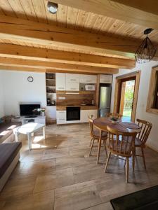 a kitchen and dining room with a table and chairs at Chalupa Nella II. in Velké Karlovice