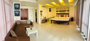a living room with a couch and a dining room at Beacon Beach Hotel Negombo in Negombo +32 photos