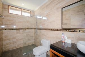 a bathroom with a toilet and a sink at Villa Riens Dream in Karangasem +32 photos