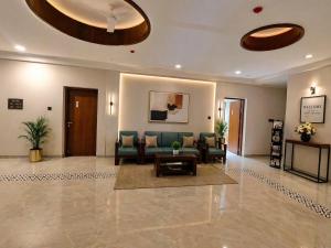 a lobby with a couch and chairs and a table at Shri Valli Residency in Palni +36 photos
