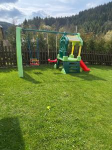 a playground in a yard with a swing at Chalupa Nella II. in Velké Karlovice