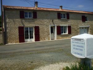 a brick building with a sign in front of it at La Piaule in Saint-Pierre-le-Vieux
