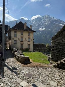 an old building with a mountain in the background at Monte Rosa Dream in Borgone +10 photos