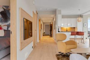 a living room and kitchen with a couch and a table at Exclusive apartment in Lofoten in Svolvær
