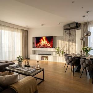 a living room with a fire on the wall at Sky & Spa Luxury Residence in Warsaw