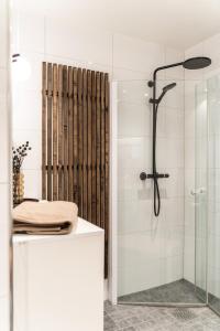 a bathroom with a shower with a glass door at Exclusive apartment in Lofoten in Svolvær +37 photos