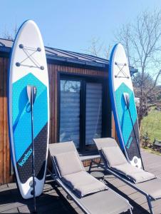 two surfboards and two chairs on a deck at Lutek in Olsztynek +10 photos