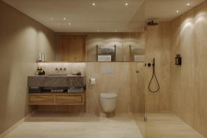 a bathroom with a toilet and a sink at Edelweiss Apartments in Lech am Arlberg +18 photos