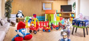 a living room filled with toys and a toy train at Hotel Arcobaleno in Fai della Paganella