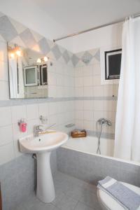a bathroom with a sink and a bath tub at Aggelina in Nydri +35 photos