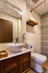 a bathroom with a sink and a toilet at Indochine Apartments in Ho Chi Minh City