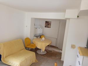 a living room with a chair and a table at Fantazija Tešnjar Apartment in Valjevo