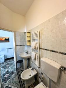 a bathroom with a white toilet and a sink at Affittacamere Giulia in Vernazza