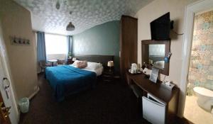 a hotel room with a bed and a bathroom at Avarest House BB Adults Only in Portrush +40 photos