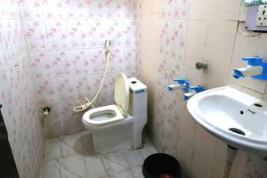 a bathroom with a toilet and a sink at Hotel Hindon Residency "Couple Friendly" in Ghaziabad