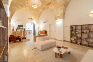 a living room with a couch and a table at Mediterranea Residence in Nardò