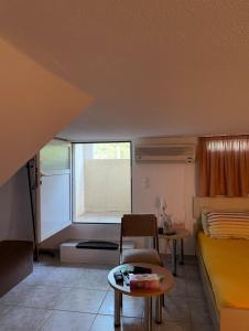 a small room with a bed and a table at Plepi's Seaside Villa in Plépi +98 photos