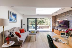 a living room with a couch and a table at Apartment in Guildford with Parking in Stoughton